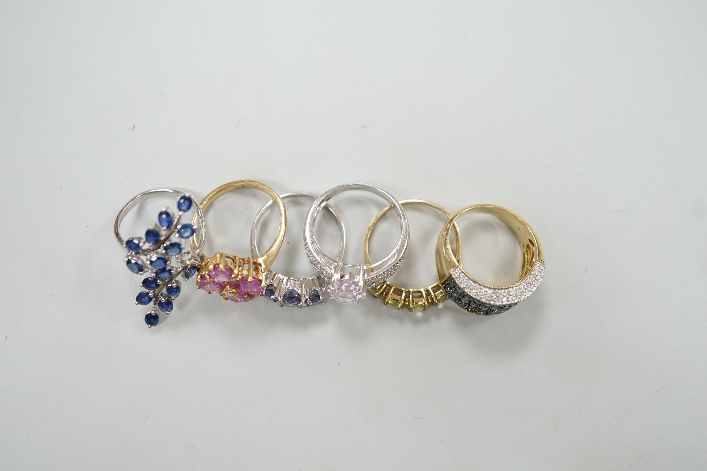 Six assorted modern 9ct gold and gem set dress rings, including three white gold, gross weight 20 grams.